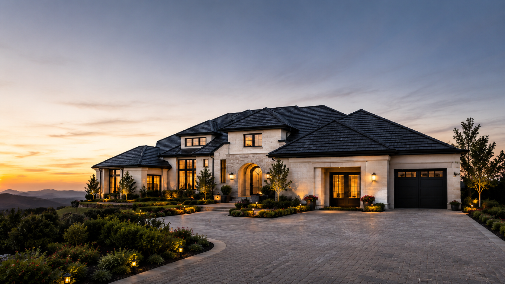 Elegant residential home with a premium dark shingle roof at sunset